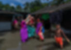 Women wearing saree  standing with kids and family in a flooded village